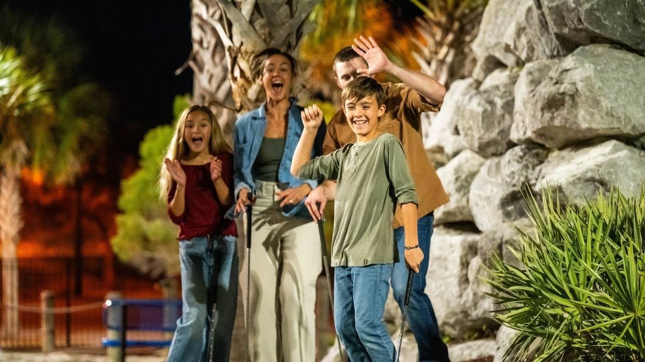 a family playing the mini golf at pcb wheel